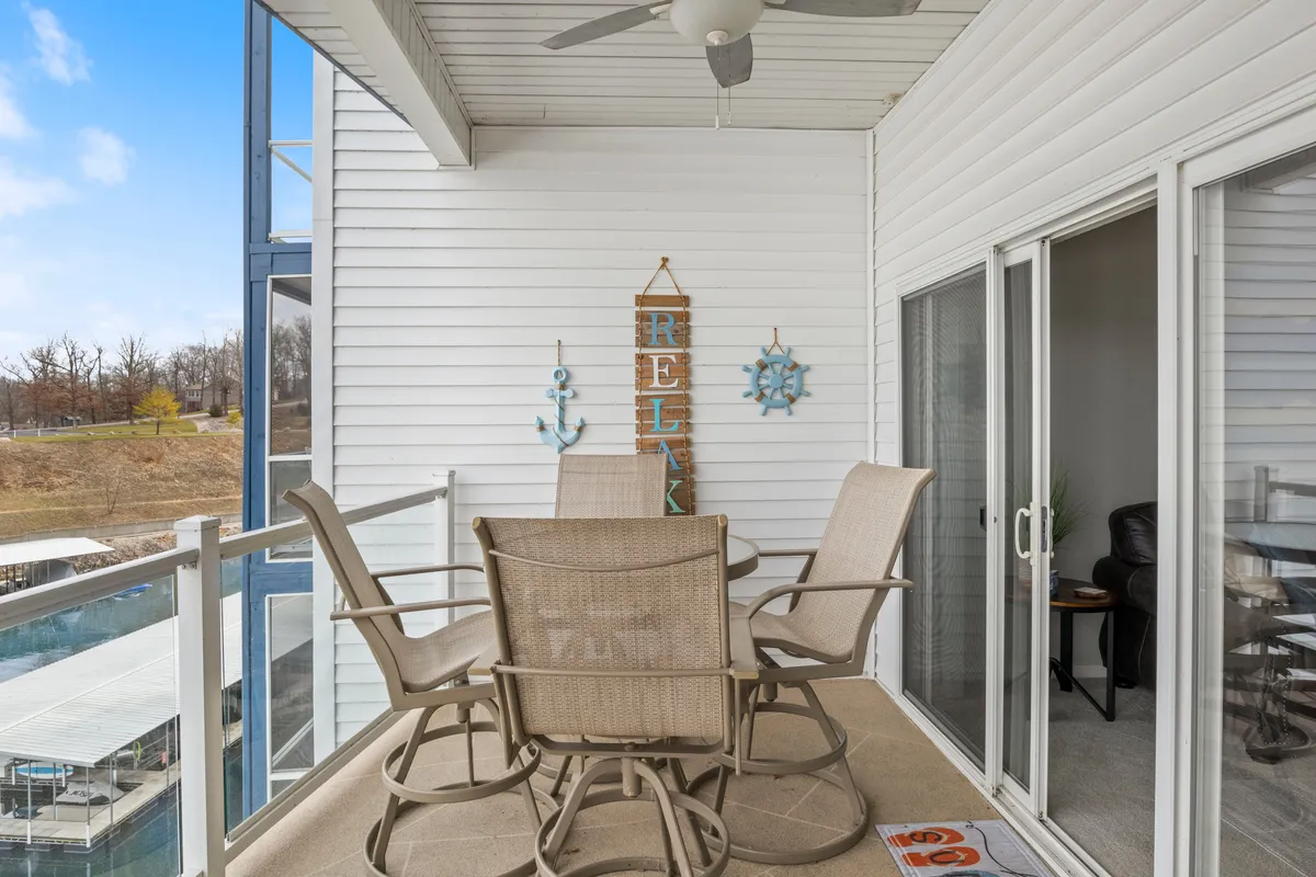 An inviting outdoor dining area with a decorative wall sign and a clear view of the marina, perfect for group gatherings and shared meals after a day of adventure.